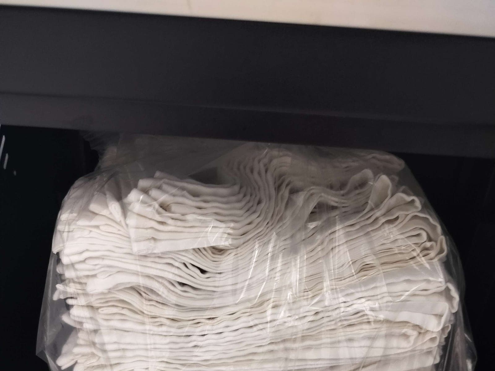 Freshly folded white towels stacked in the store